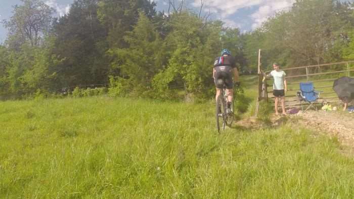 A friendly volunteer opens the gate leading to Singletrack #1.